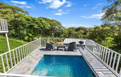 a swimming pool on the deck of a house at Casa amor del sol apartment # 3 in Tarcoles