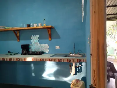 a kitchen with a sink and a blue wall at Mono titi third floor in Manuel Antonio