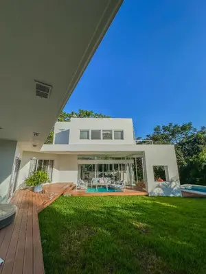 a large white house with a lawn in front of it at Ocean View Villa 2min to beach - Casa Cantini in Montezuma