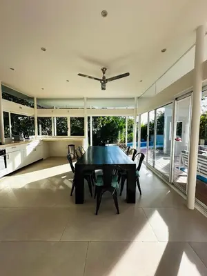 a dining room with a black table and chairs at Ocean View Villa 2min to beach - Casa Cantini in Montezuma