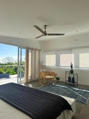 a bedroom with a bed and a ceiling fan at Ocean View Villa 2min to beach - Casa Cantini in Montezuma