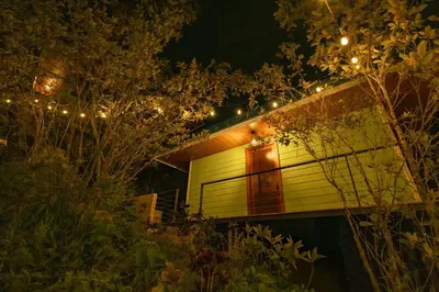 a house with lights on the side of it at night at Tardes Doradas in Quepos