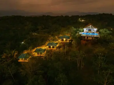 an aerial view of two houses in the woods at night at Tardes Doradas in Quepos