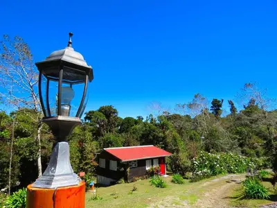a street light in front of a small house at Finca La Picuda Quetzal Cottage in Cartago