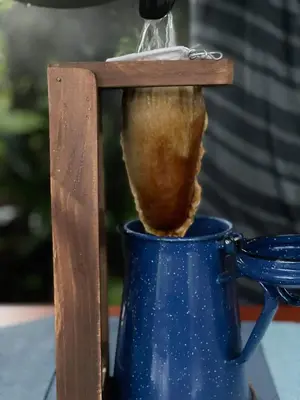 a vase with a wooden handle sticking out of it at Aracari Garden Hostel in Tortuguero
