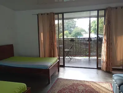 a bedroom with a bed and a sliding glass door at Casa la Rosa third floor 5 in Quepos