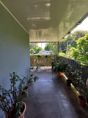 a patio with potted plants and a fence at Casa la Rosa third floor 5 in Quepos