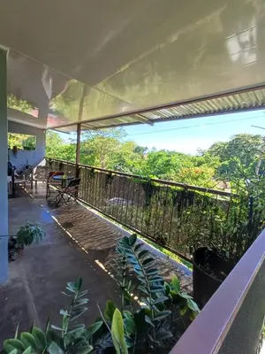 a balcony of a house with a view of trees at Casa la Rosa third floor 5 in Quepos