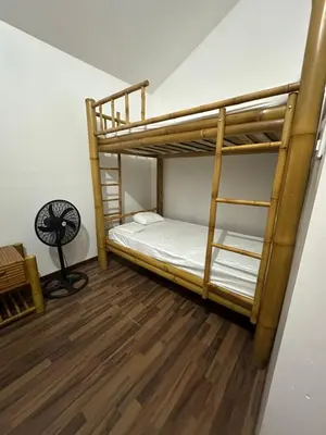 a bedroom with two bunk beds and a wooden floor at Aracari Eco Lodge in Corazón de Jesús