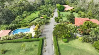 an aerial view of a house with a driveway at Casa Caletas Boutique Hotel in Puerto Coyote