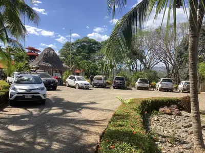 a group of cars parked in a parking lot at Casa Caletas Boutique Hotel in Puerto Coyote