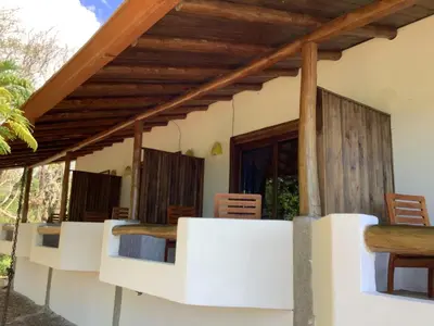 a room with beds and wooden ceilings at Casa Caletas Boutique Hotel in Puerto Coyote