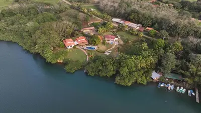 an aerial view of a house on an island in the water at Casa Caletas Boutique Hotel in Puerto Coyote