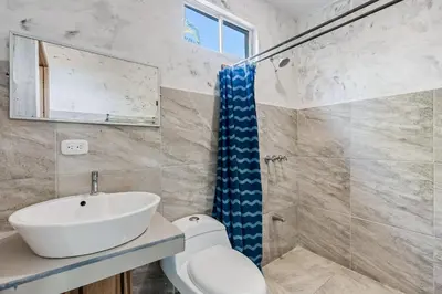 a bathroom with a sink and a shower at Hotel Tamarindo INN - 1 mi to Tamarindo Beach in Tamarindo