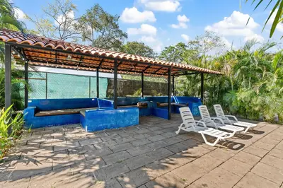 a group of chairs sitting on a patio at Hotel Tamarindo INN - 1 mi to Tamarindo Beach in Tamarindo