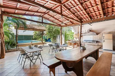 an outdoor kitchen and dining area with tables and chairs at Hotel Tamarindo INN - 1 mi to Tamarindo Beach in Tamarindo