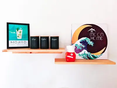 a shelf with three coffee cups and a picture of a wave at Moon Home Sea #4 in Playa hermosa