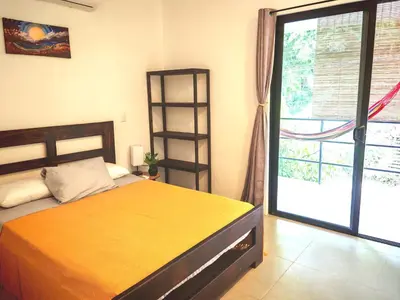 a bedroom with a bed and a large window at Moon Home Sea #4 in Playa hermosa