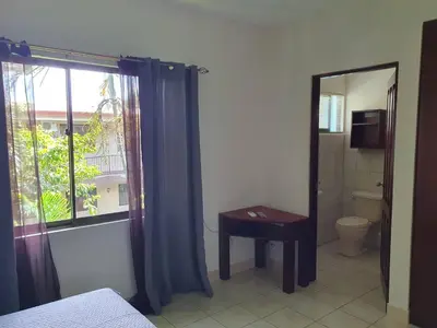 a room with a bathroom with a toilet and a window at Apartment hotel Marina Loft 207 in Coco