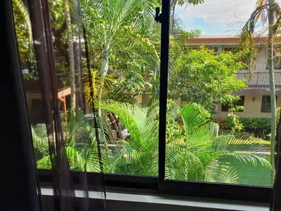 an open window with a view of a garden at Apartment hotel Marina Loft 207 in Coco