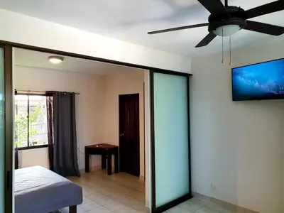 a bedroom with a ceiling fan and a bed at Apartment hotel Marina Loft 207 in Coco