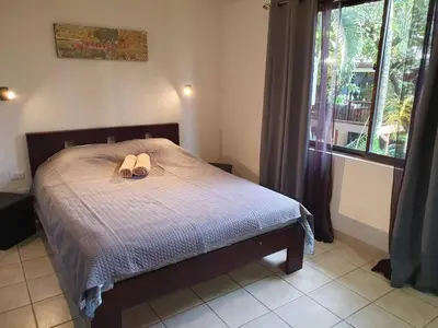 a bedroom with a bed with a pair of shoes on it at Apartment hotel Marina Loft 207 in Coco