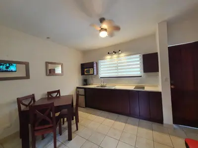 a kitchen with a table and a sink and a window at Marina Loft Condos 223 in Coco
