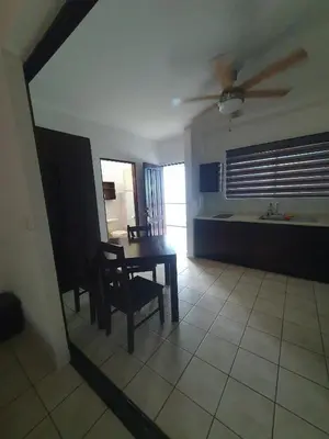 a living room with a dining room table and a kitchen at Marina Loft Condos 218 in Coco