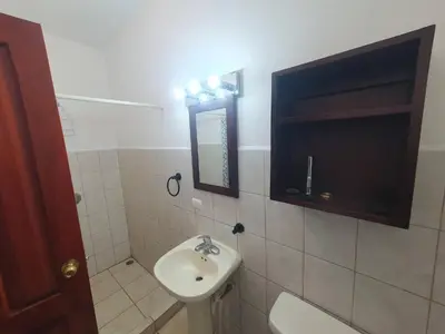a bathroom with a sink and a toilet and a mirror at Marina Loft Condos 218 in Coco