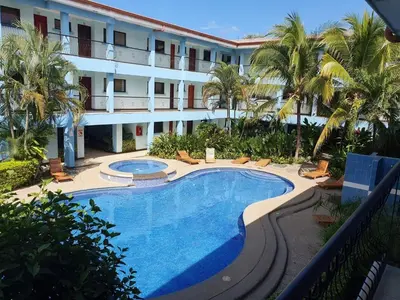 an external view of a hotel with a swimming pool at Marina Loft Condos 218 in Coco