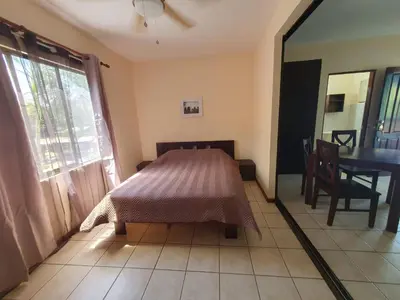 a bedroom with a bed and a table and a window at Marina Loft Condos 218 in Coco