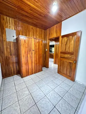 an empty room with wooden walls and a tile floor at Alojamiento tranquilo rodeado de paz y serenidad in Río Negro