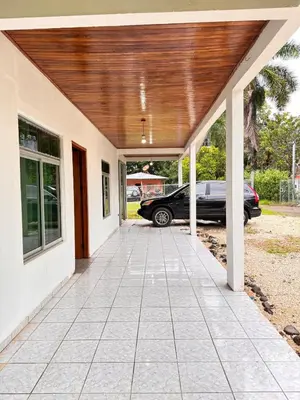 a porch of a house with a car parked at Alojamiento tranquilo rodeado de paz y serenidad in Río Negro
