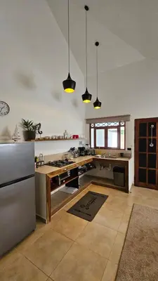 a large kitchen with a stainless steel refrigerator at Zoa Villas - Santa Teresa - 2 min walk to beach in Santa Teresa Beach