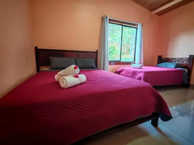 a bedroom with two beds with a teddy bear on it at Monteverde Twins in Monteverde Costa Rica
