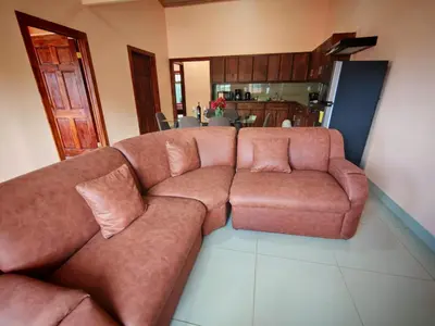a brown couch sitting in a living room at Monteverde Twins in Monteverde Costa Rica