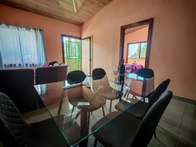a dining room with a glass table and chairs at Monteverde Twins in Monteverde Costa Rica