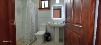 a bathroom with a toilet and a sink and a door at Monteverde Twins in Monteverde Costa Rica