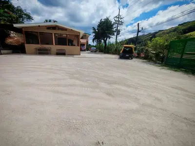 a large parking lot with a building and a car parked at Monteverde Twins in Monteverde Costa Rica