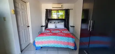 a bedroom with a bed with a red blanket and a window at Vista perfecta dos ap 8 in Artola