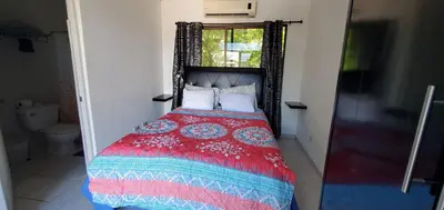 a bedroom with a bed with a red blanket and a window at Vista perfecta dos ap 8 in Artola