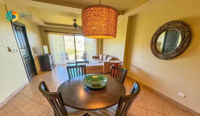 a dining room with a table and chairs and a couch at Vista Condor Lodge in Puerto Viejo