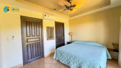 a bedroom with a bed and a ceiling fan at Vista Condor Lodge in Puerto Viejo
