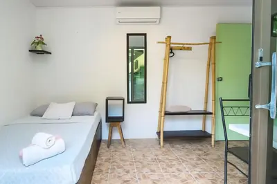 a room with two beds and a mirror at Abacaxi Box Studios in Santa Teresa Beach