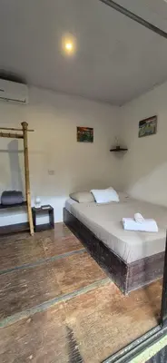 a bedroom with two beds in a room at Abacaxi Box Studios in Santa Teresa Beach