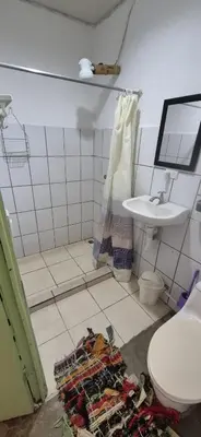 a bathroom with a toilet and a sink at Abacaxi Box Studios in Santa Teresa Beach