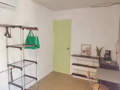 a room with a shelf and a table and a door at Abacaxi Box Studios in Santa Teresa Beach