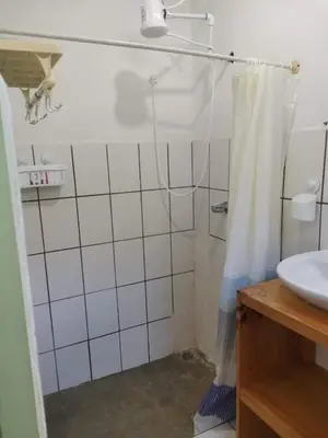 a bathroom with a shower and a sink at Abacaxi Box Studios in Santa Teresa Beach