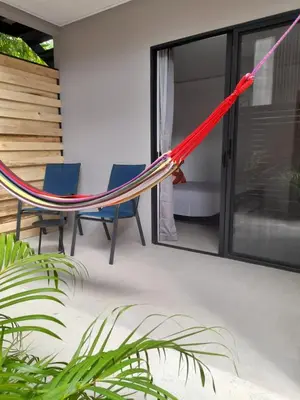 a hammock on the patio of a house at Moon Home Sun #3 in Playa hermosa