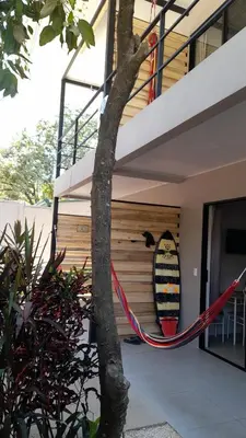 a surfboard hanging on the side of a house at Moon Home Sun #3 in Playa hermosa